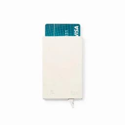 A card holder in white, featuring a slim design for storing credit cards. It has a logo on the front.