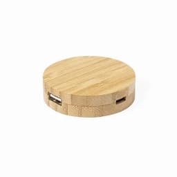 A round bamboo charging station featuring two USB ports, showcasing a natural wood finish.