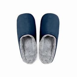 A pair of navy blue slippers with a soft grey interior. They feature a slip-on design for comfort.