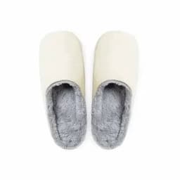A pair of cream-coloured slippers with grey, fluffy lining, designed for comfort and warmth.