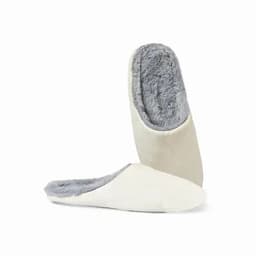 A pair of cream-coloured slippers with a soft grey fur lining, featuring a slip-on design.