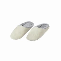 A pair of cream-coloured slippers with a soft grey lining, featuring a slip-on design.