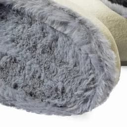 A grey and cream slipper with a fluffy interior and a soft texture. It features a rounded edge for comfort.