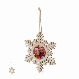 A wooden snowflake-shaped ornament with a circular frame for a photo, featuring a natural wood finish and a hanging string.