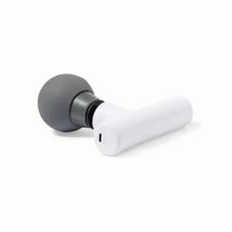 A massage device with a grey spherical head and a white handle, featuring a charging port.