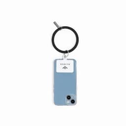 A phone case in light blue with a circular black keyring and a logo, designed for a phone model.