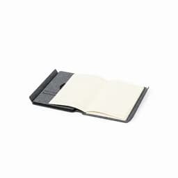 A notebook with a grey cover, featuring blank pages and an open design for easy writing.