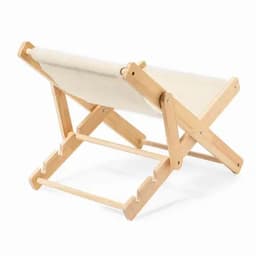A wooden folding chair with a cream fabric seat, showcasing a minimalist design. Features a light wood finish.