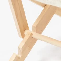 A wooden chair frame featuring light-coloured wood with a cross-support design, showcasing craftsmanship details.