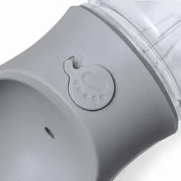 A drink bottle in grey with a clear section, featuring a logo and a prominent button on the side.