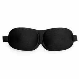 A sleep mask in black with a smooth surface and adjustable straps. Features a contoured design for comfort.