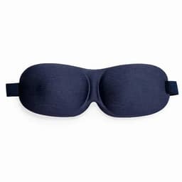 A sleep mask in navy blue, featuring a curved design and an adjustable strap.