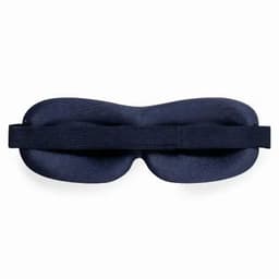 A sleep mask in navy blue, featuring a curved design and an adjustable strap for comfort.