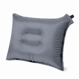 A grey inflatable pillow with a central indentation and a side handle for easy transport.