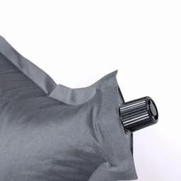 A grey inflatable pillow featuring a black valve for inflation and deflation.