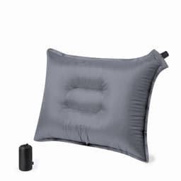 An inflatable travel pillow in grey, featuring a contoured design, with a matching compact storage bag.