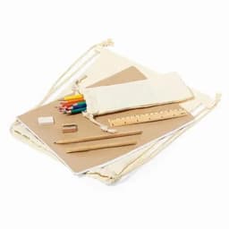 A drawstring bag containing art supplies: coloured pencils, paper, a ruler, an eraser, and wooden pencils.