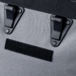 A grey bike bag featuring black clasps and a velcro strip for secure fastening.