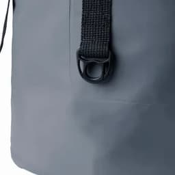A grey promotional bag featuring a black strap and a plastic clasp. It has a minimalist design and a sturdy appearance.