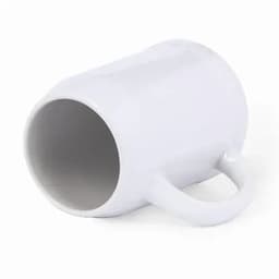 A white mug with a handle, lying on its side. The interior is also white.
