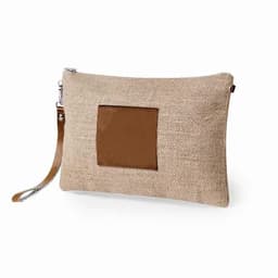 A beige clutch bag made of burlap with a brown leather patch, featuring a wrist strap and zip closure.