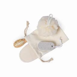 A bath gift set featuring a loofah, a pumice stone, a wooden brush, and a canvas pouch, all in neutral colours.