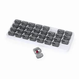 A medication organiser with grey compartments labelled by day, featuring a small red pill in one section.