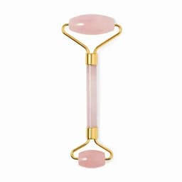 A facial roller with pink jade stone and gold accents, featuring two smooth ends for skincare.