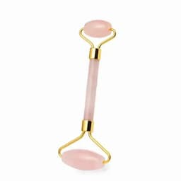 A rose quartz facial roller with a gold handle, featuring rounded ends for skincare application.