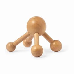 A wooden massage tool with a spherical body and three rounded legs, designed for relaxation and tension relief.