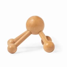 A wooden massager with three legs and spherical ends, featuring a light natural wood finish.
