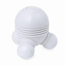 A white massage ball with a dome shape and three rounded feet for stability, featuring textured sides.