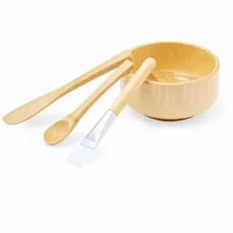 A bamboo bowl set featuring a bowl, a spoon, and a spatula, all in natural wood tones.