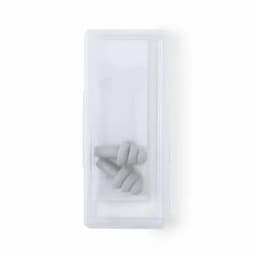 A clear container with grey earplugs inside. The container is rectangular and has a simple design.