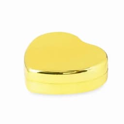 A heart-shaped container in shiny gold. The product has a reflective surface and a clasp closure.
