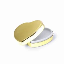 A heart-shaped gold box with a white interior, slightly open to reveal its contents.