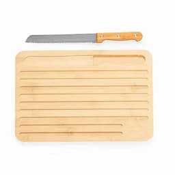 A bamboo cutting board with a serrated knife placed on top. The board features lined grooves for cutting.