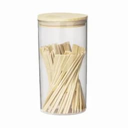 A clear jar with a wooden lid, containing numerous wooden sticks arranged vertically inside.