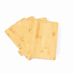 A set of four bamboo chopping boards in a natural wood finish, featuring subtle engraved designs.
