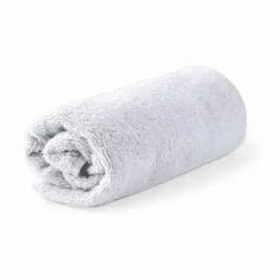A rolled grey towel made of soft fabric, neatly arranged and showcasing a plush texture.