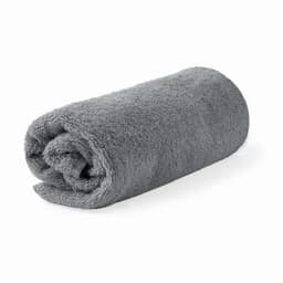 A grey rolled towel made of soft, fluffy material, showcasing a simple and elegant design.