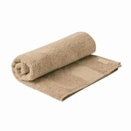 A rolled beige towel with a textured surface and a flat section, featuring a small branding label.
