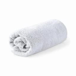 A rolled grey towel made of soft fabric, showcasing a plush texture.