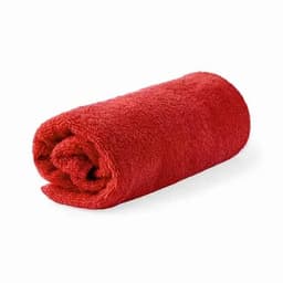 A rolled red towel made from soft, fluffy material, featuring a vibrant colour and a plush texture.