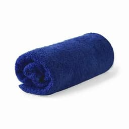 A rolled, fluffy towel in a vibrant navy blue colour, featuring a textured surface. It has a simple, unbranded design.