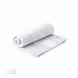 A rolled grey towel made of soft fabric, featuring a small logo on one side.