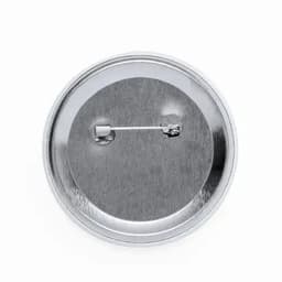 A round metallic pinback button featuring a smooth, reflective surface with a pin attachment on the back.