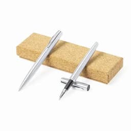 A set of silver pens resting on a cork base, featuring a sleek design with one pen capped.
