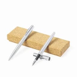 A set of silver pens resting on a rectangular cork block, showcasing their sleek design.