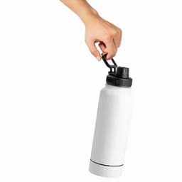 A drink bottle in white with a black lid, held by a hand. It features a clip for easy carrying.